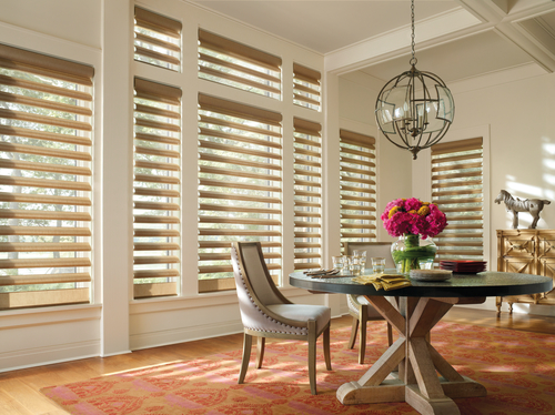 motorized gold window shades in a dining room on large windows