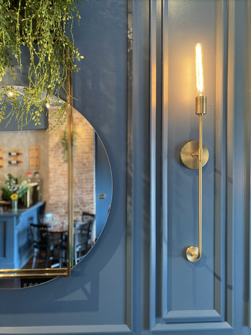 old havana wall detail blue wall with hanging plant and mirror gold vintage lighting