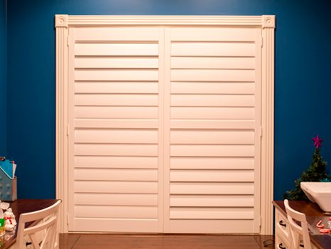 blue painted room in Naperville with white shutters on windows