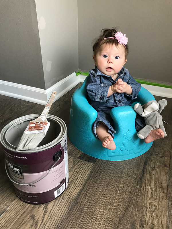 baby with a paint can during DIY painting