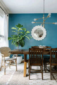 blue wall with green plants dining room