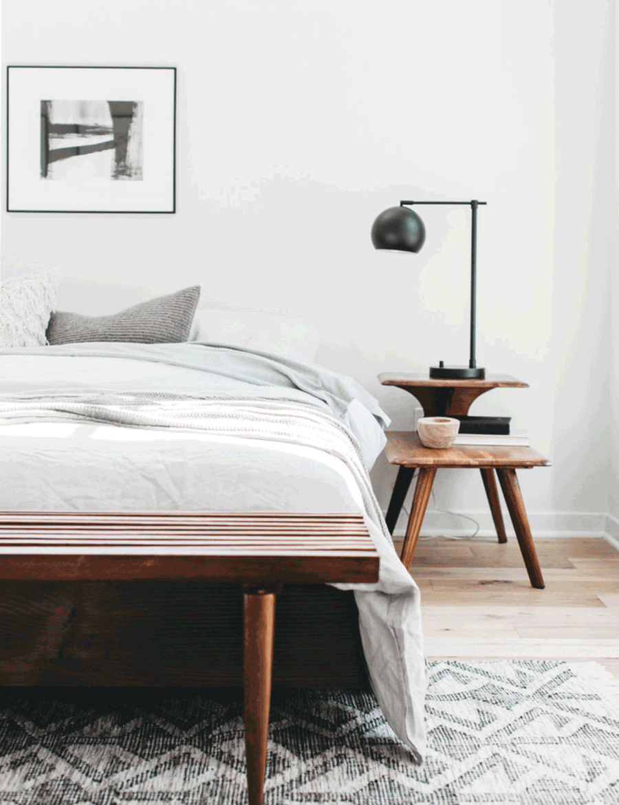 white walls rust orange wooden furniture gray rug and gray bedding