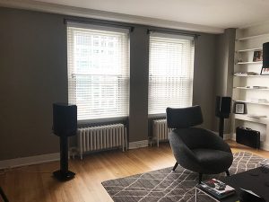 living room with gray walls with hunter douglas everwood collection blinds in Chicago 60611