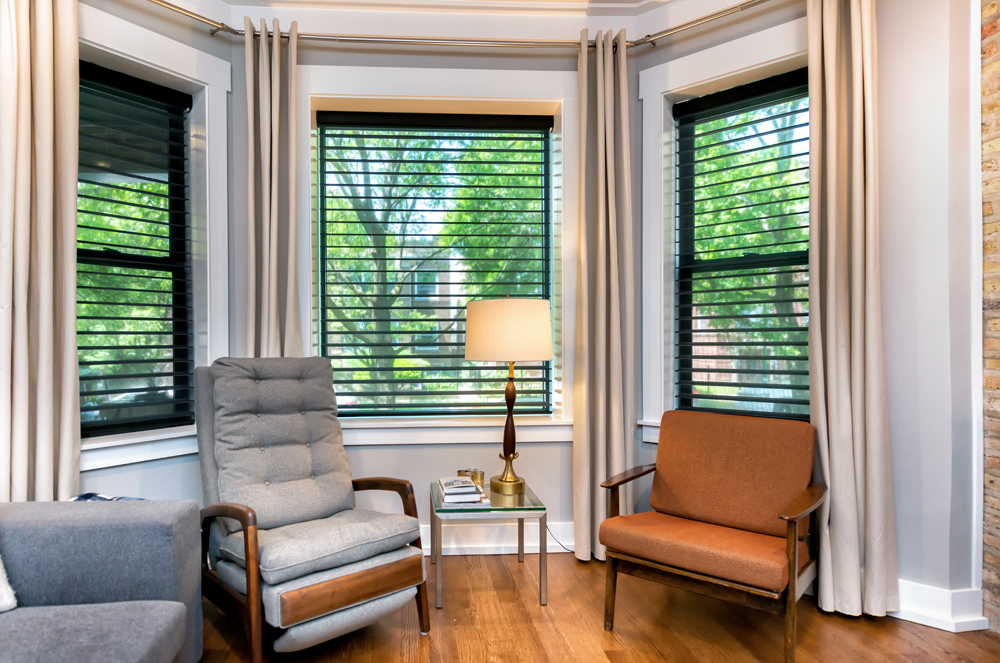 black sheer shades in the bay window area of a Chicago home