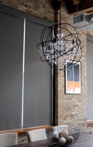 charcoal gray roller shades with exposed brick walls in Chicago IL