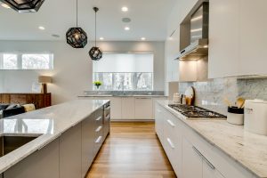 white kitchen with gray island and white roller shades in Chicago IL