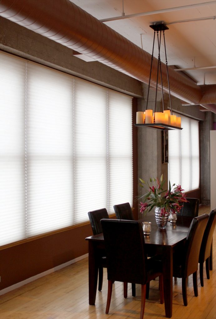 urban industrial loft with wall to wall windows covered with cellular shades in Chicago IL