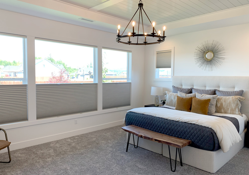 master bedroom with white, gold and navy blue colors, windows with cellular shades in Portland OR