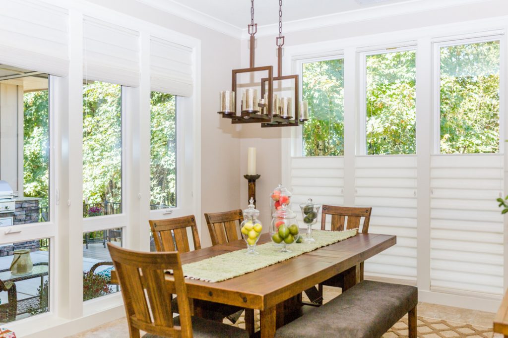 farmhouse style dining room with tall windows covered with roman shades in Portland OR home