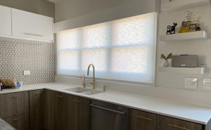 kitchen with gold hardware and gray roller shade behind sink in Chicago IL