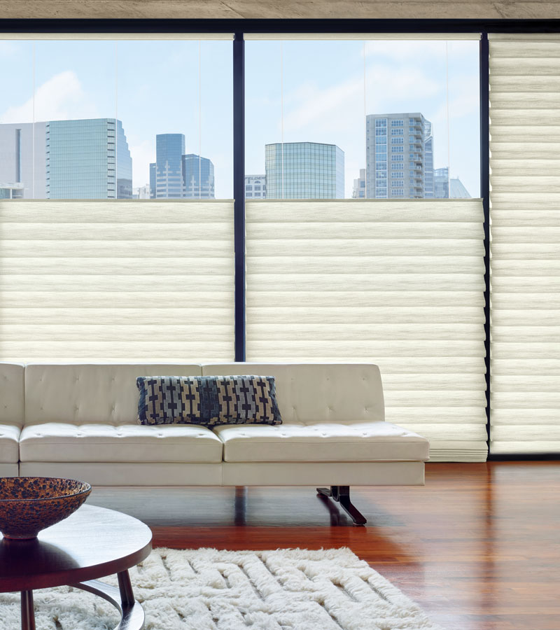 living room with floor to ceiling windows with top down roman motorized shades Portland OR