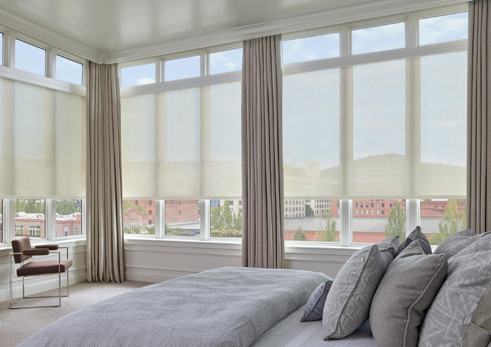 tall windows on entire wall with draperies and roller screen shades in Portland OR