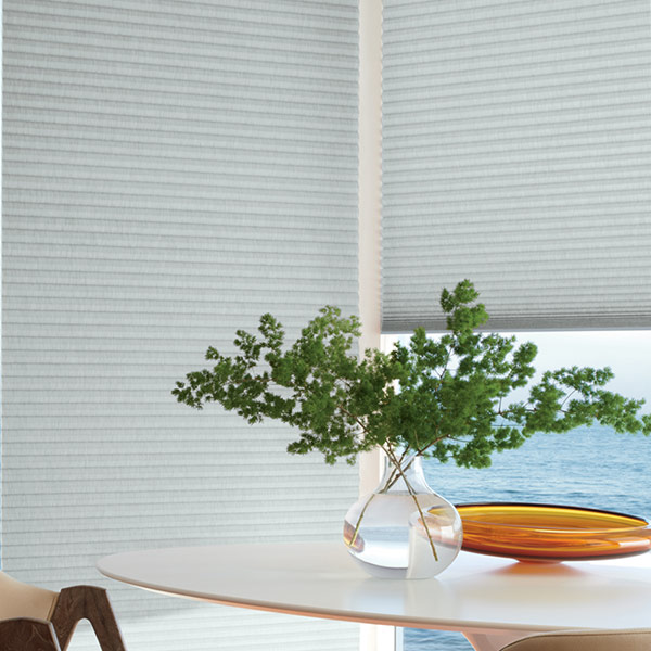 corner of dining room floor to ceiling windows with duette honeycomb shades Vancouver WA