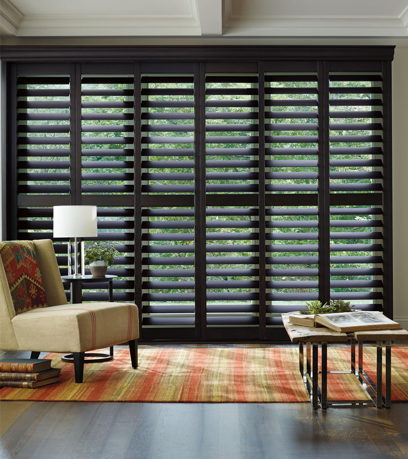 floor to ceiling living room window with wood shutters in Portland OR