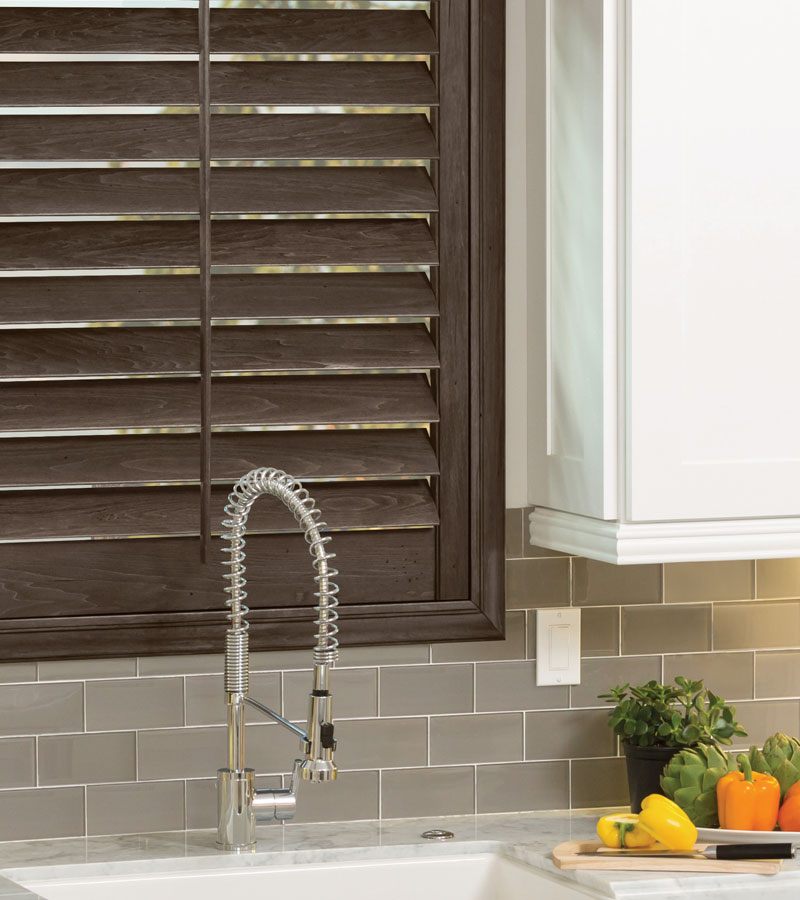 Portland OR kitchen window with hardwood shutters behind sink