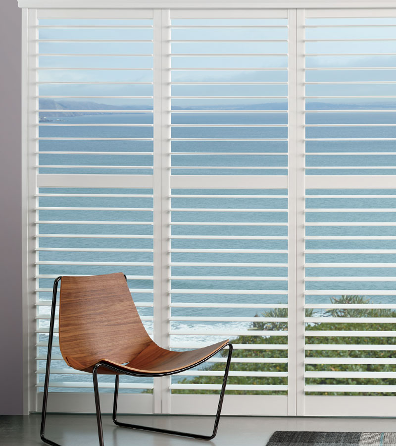 large window covered with white plantation shutters in Portland OR