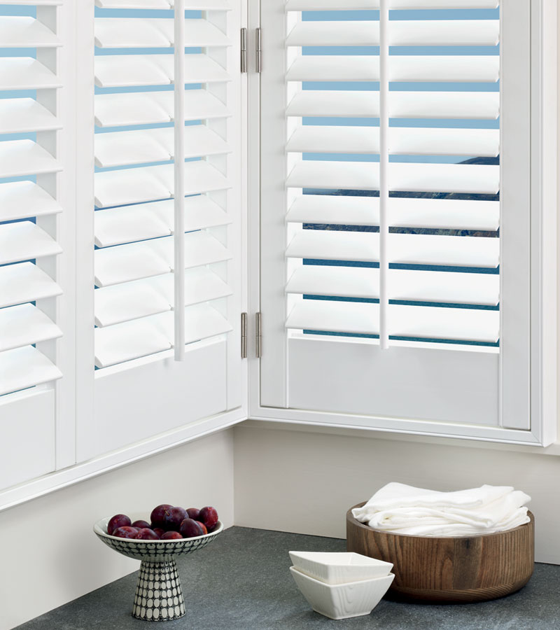 white window shutters with center tilt bar in the corner of the room in Vancouver WA