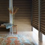 room darkening roman shades in taupe color with blue and orange room decor