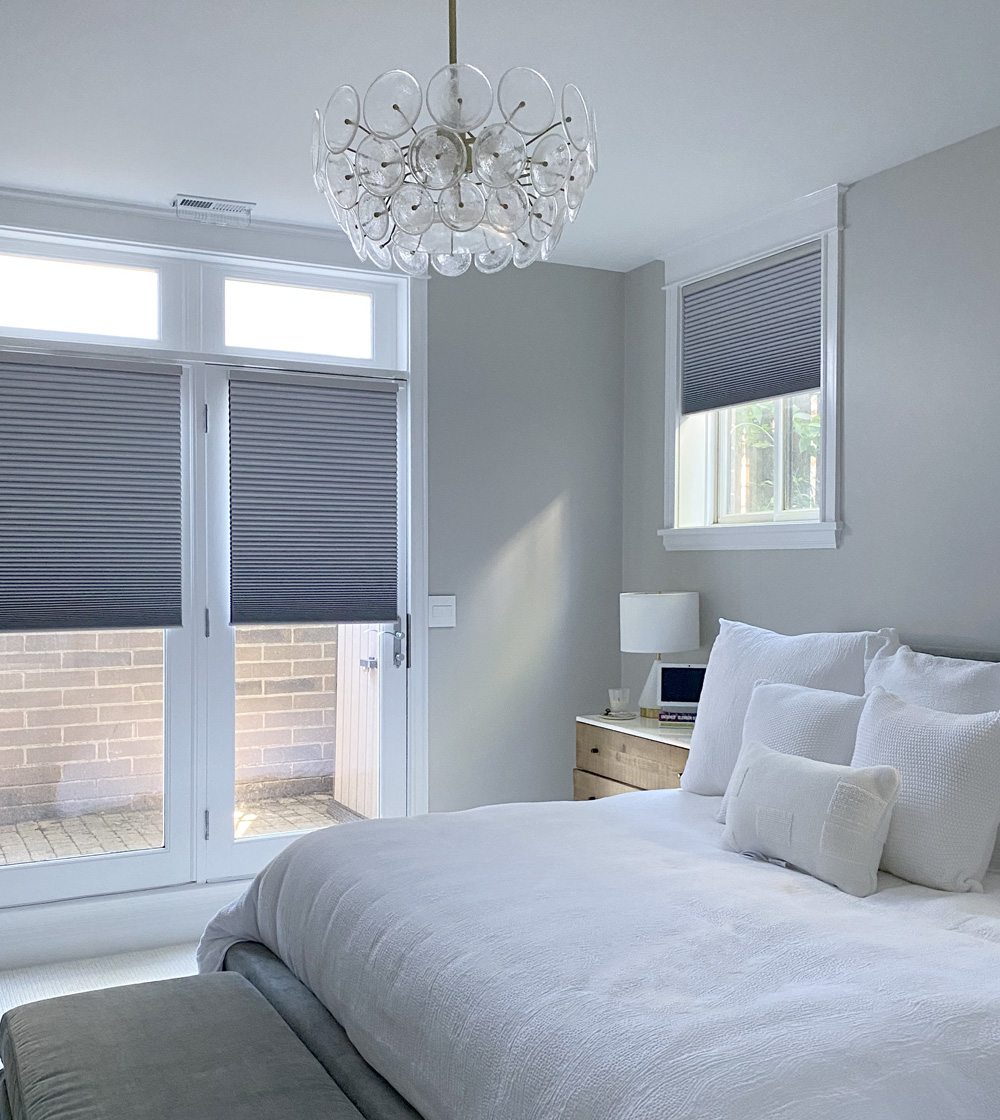 white bedroom with gray honeycomb shades on french doors in Chicago IL