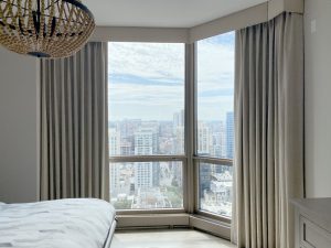 neutral roller shades layered with beige draperies in Chicago Gold Coast condo