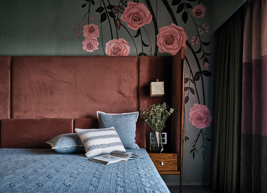 blue and coral in bedroom design with floral accent wall