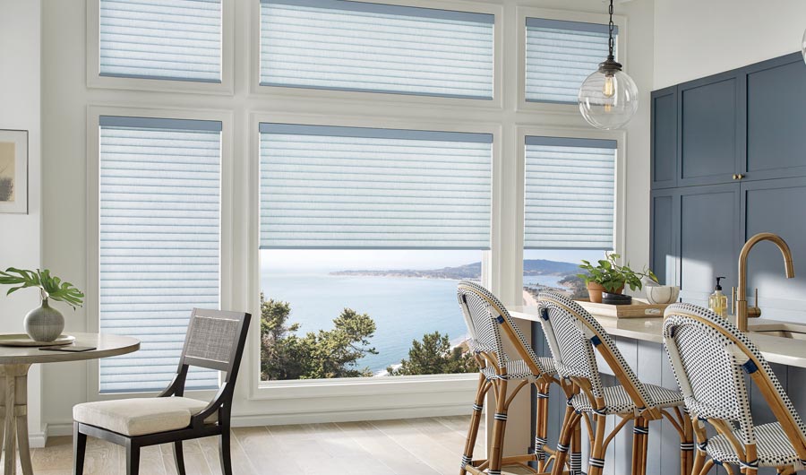 cellular roller shades on multiple windows in a kitchen with lake views