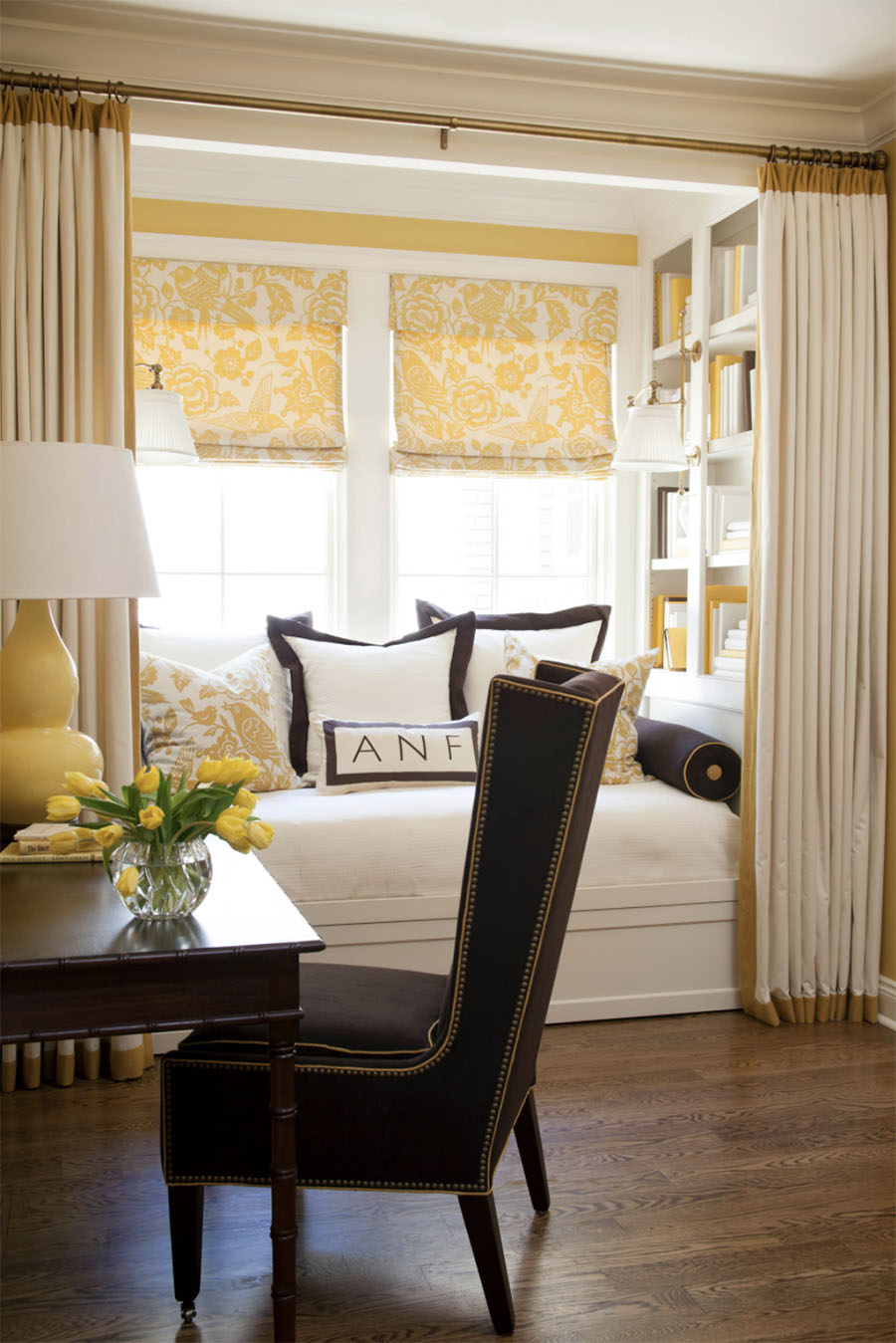 Yellow shades in bay window in kitchen.