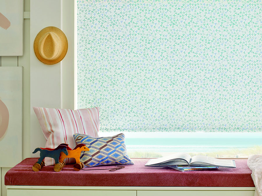 Window seat with patterned roller shades