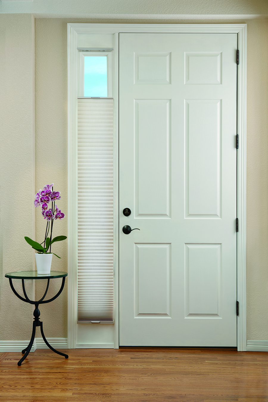 honeycomb shades covers the sidelight of entryway door in Portland OR