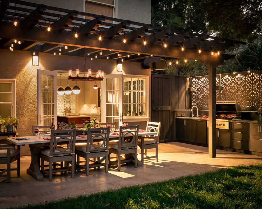 upgraded backyard at night with pergola