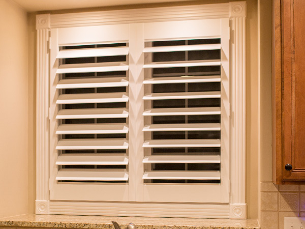 kitchen window with interior shutters in view through position in Naperville IL