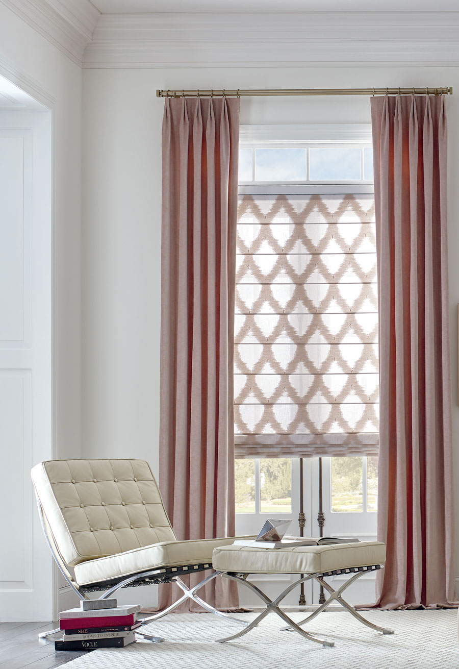 rose gold inspired drapery panels and patterned roman shades in white living room