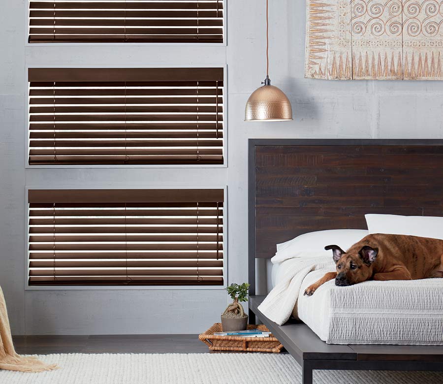 dark wood blinds on triple windows in master bedroom