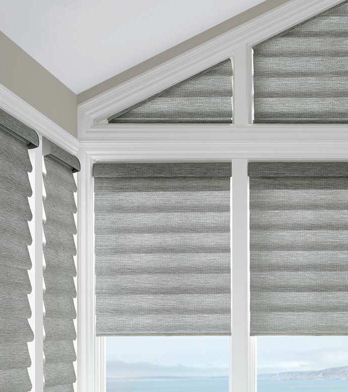 gray shades in corner window framed by white wood beams