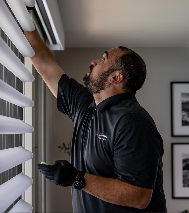 window treatment installer working on pirouette shades in Chicago, IL