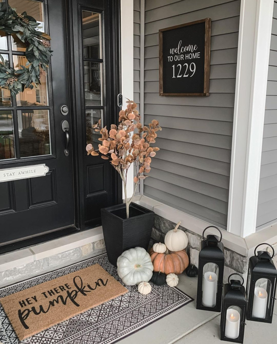 entrance of home with pumpkins and lanterns