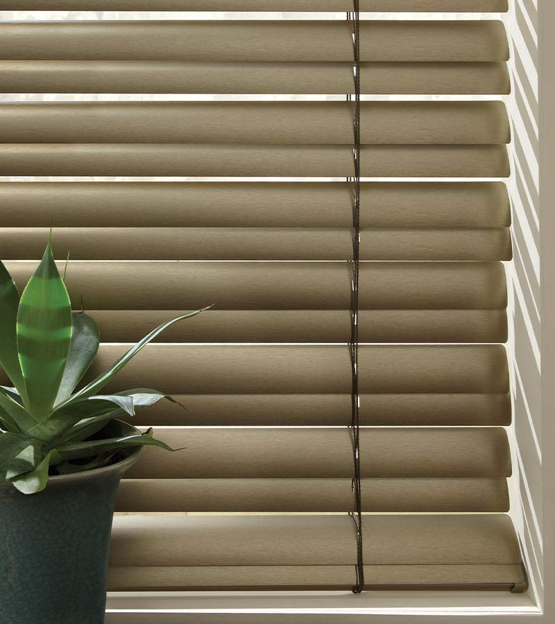 detail of brown cordless childsafe blinds next to houseplant in Portland, OR