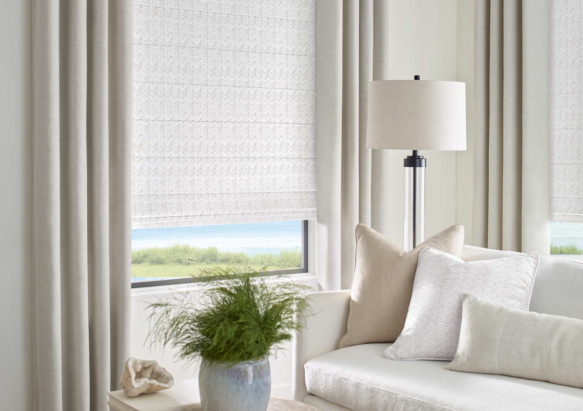 skylinewindowcoveringsdesignstudiopatterenedromanshadeswithcreamdraperies Skyline