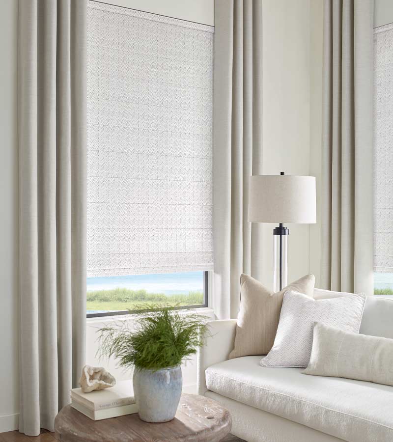 chevron patterned fabric roman shades with beige draperies