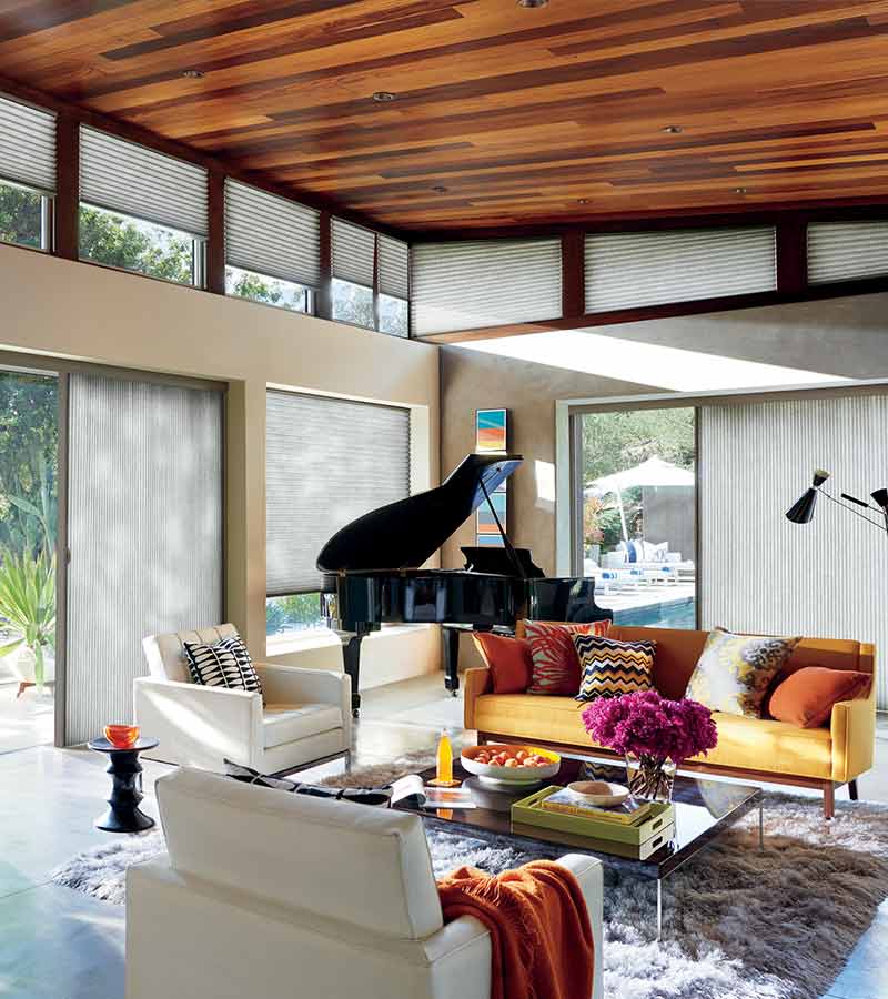 boho chic sunroom with glass doors and cellular window shades in Portland, OR