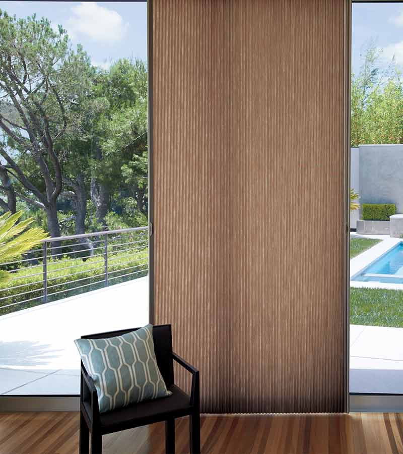 glass patio door with brown honeycomb shades with smart shade technology