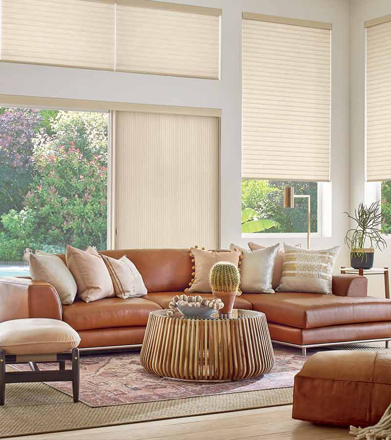 western boho living room with large windows and sliding glass window panels