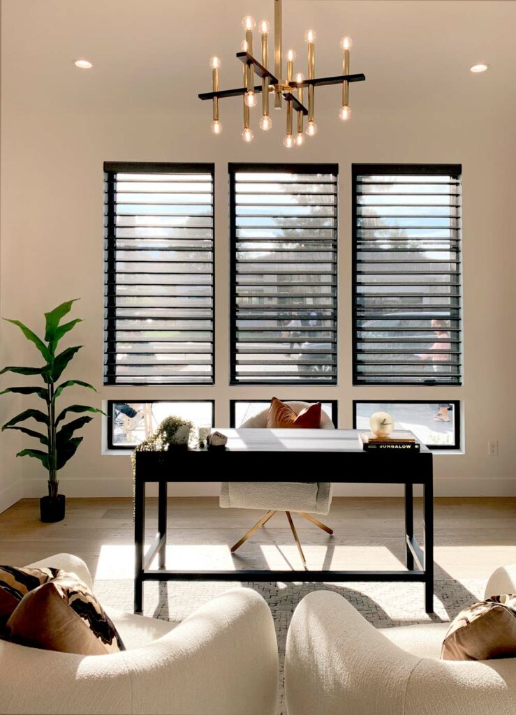 black silhouette shades on three windows in designer home office