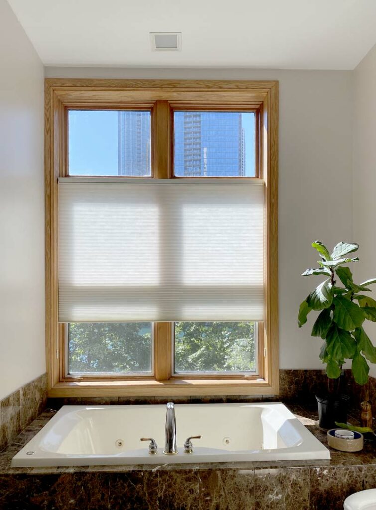 window over tub with honeycomb shade open transom top