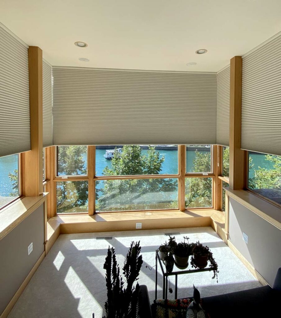 sunroom with floor to ceiling windows covered with honeycomb shades