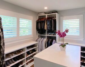 walk-in closet with white shutters