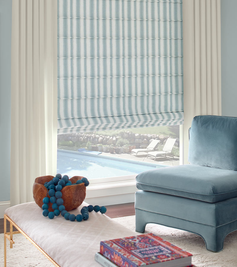 modern living room with plush velvet chair and drapes with blue and white stripes Chicago, IL