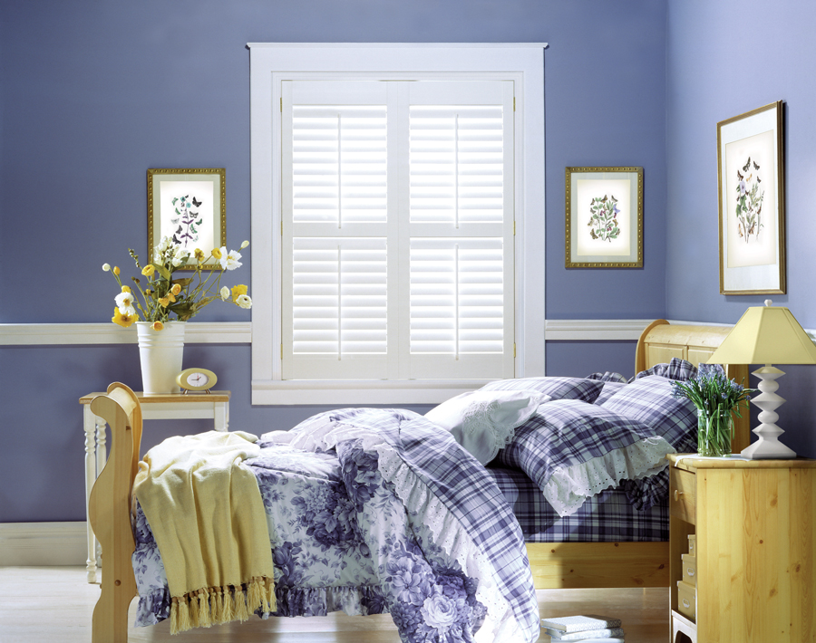 very peri wall color with white plantation shutters in girls bedroom Chicago, il