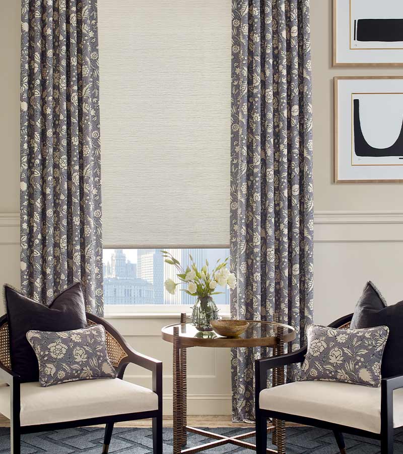 modern living room drapery in cream and lavender color overlaying automatic roller shades
