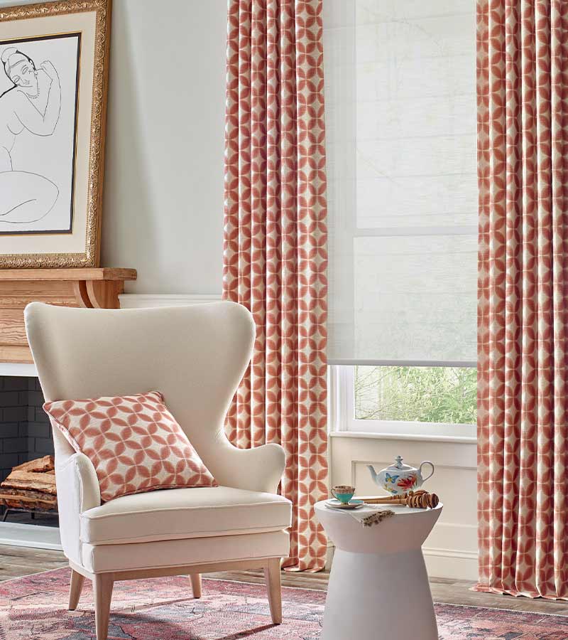 red and cream pattern on curtains with dual opacity gray roller shades in naperville, IL